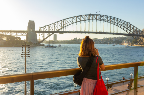 Woman at Sydney Harbor Bridge - AUS - Travel Deals from the USA - Wake Up Here